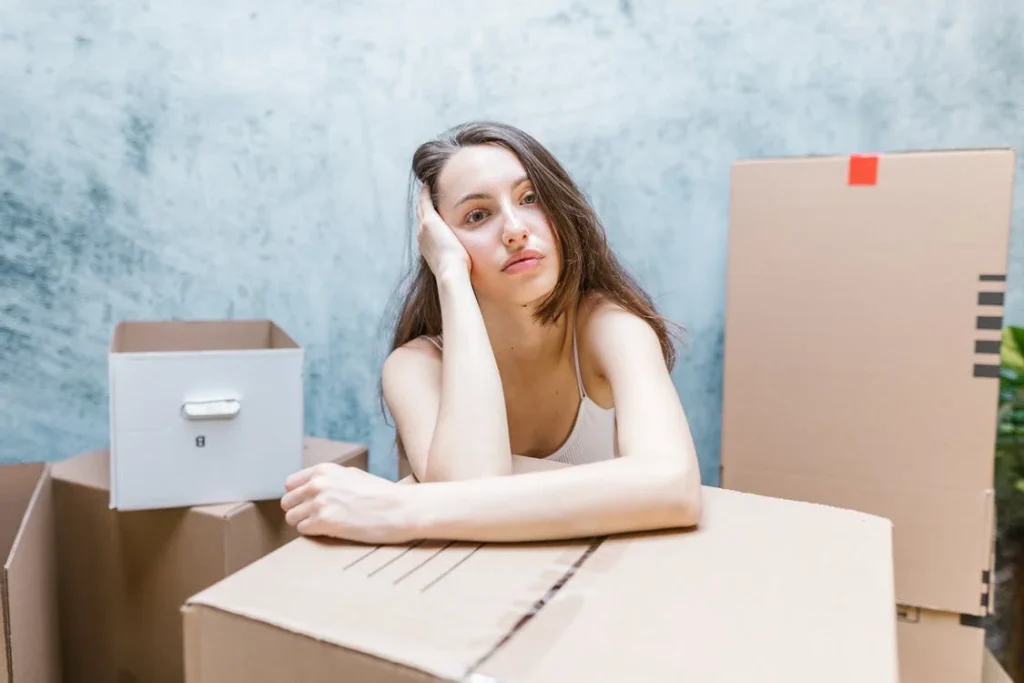 Worried woman with moving boxes