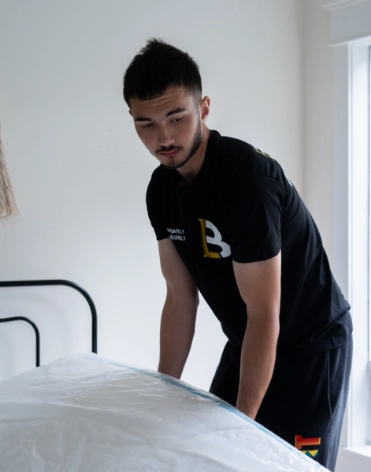 Mover lifting a mattress